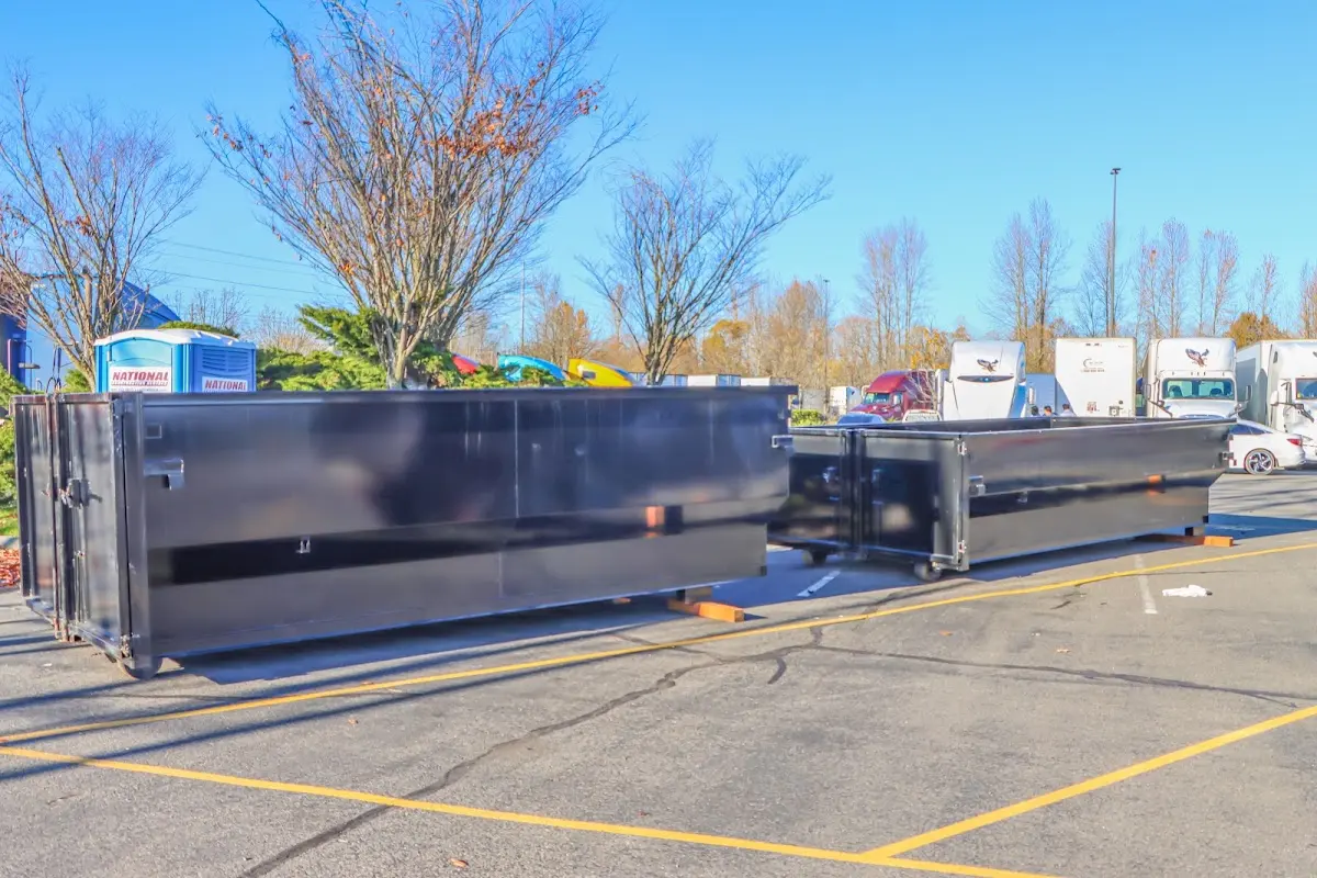 Professional dumpster rental service with roll-off container on residential driveway in Ferndale